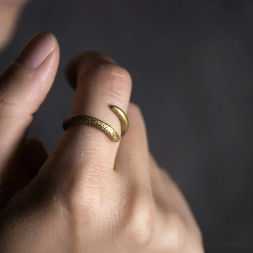 Tibetan copper spiral ring worn on hand showing how adjustable open band fits on fingers