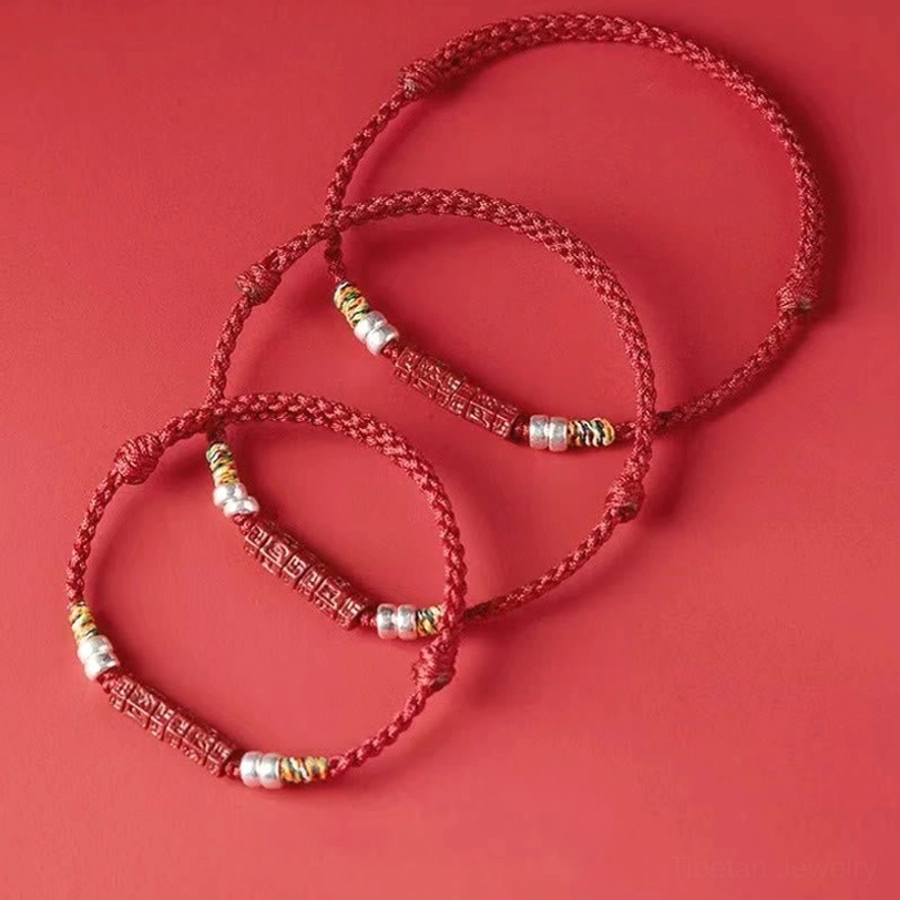Spiritual protection bracelet featuring Om Mani Padme Hum and traditional Tibetan red cord