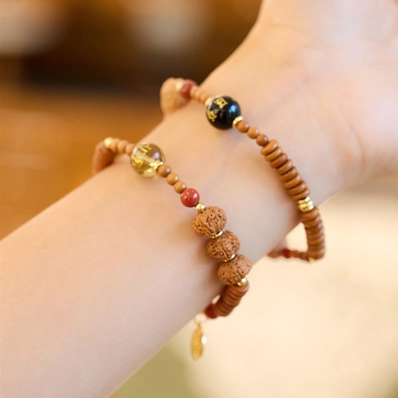 Stacked tibetan bodhi seed bracelets on wrist, double-bracelet wearing style with gold Fu charm