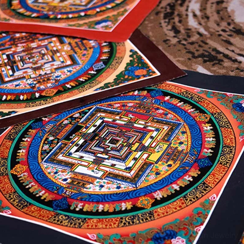 Stacked Tibetan mandala thangkas showing varied color designs with red and black border accents