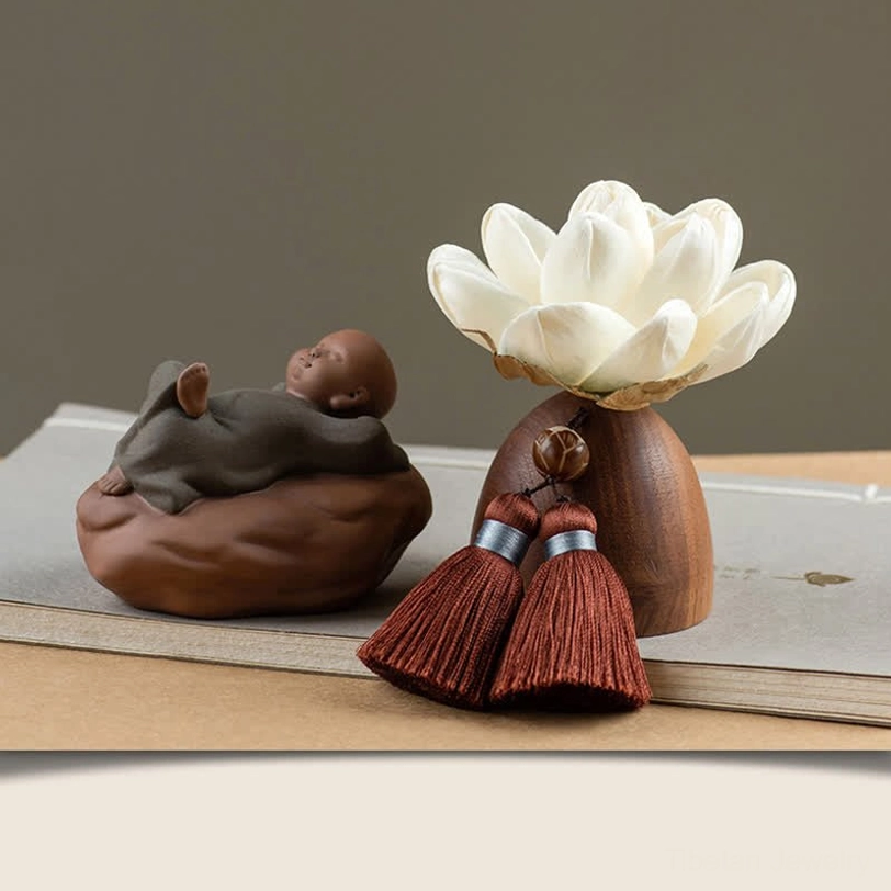 Standing Buddha figurine with peach wood lotus base and white fabric flower meditation decor
