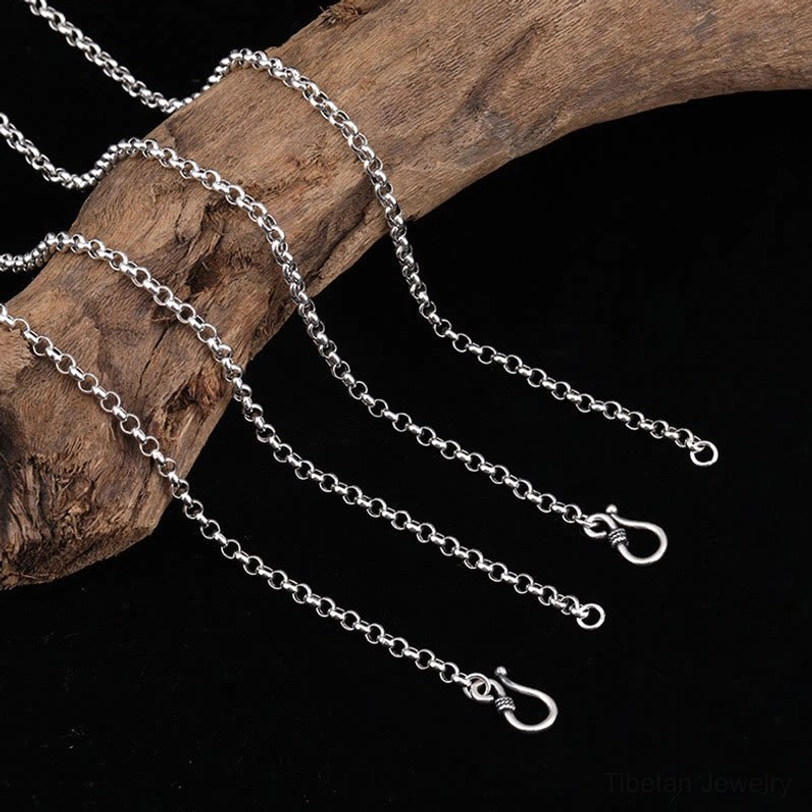 Sterling silver chain options multiple lengths with lobster claw clasps on wooden branch and black backdrop