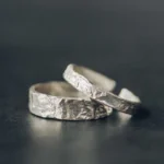 925 sterling silver hammered couple rings flat lay - adjustable open bands with textured finish