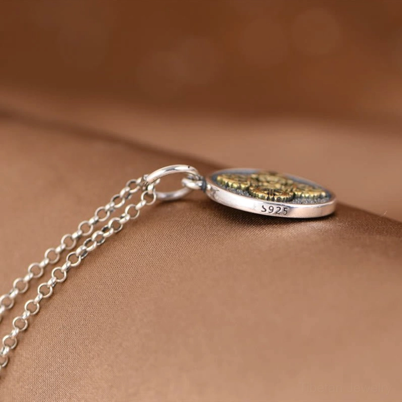 Sterling silver double dorje vajra pendant flat lay with S925 hallmark and chain display