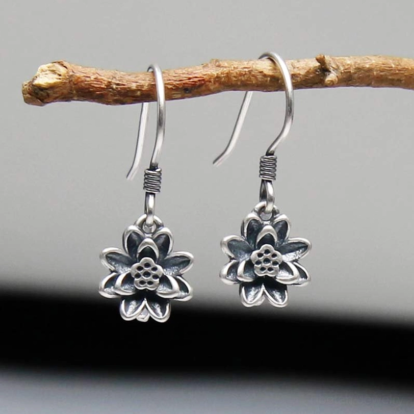 925 sterling silver lotus flower drop earrings front view hanging on wooden branch showing detailed 3D layered lotus pendant design