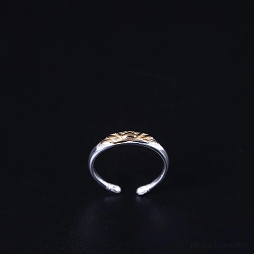 Sterling silver lotus rebirth ring front view slim open band with small gold lotus accent detail