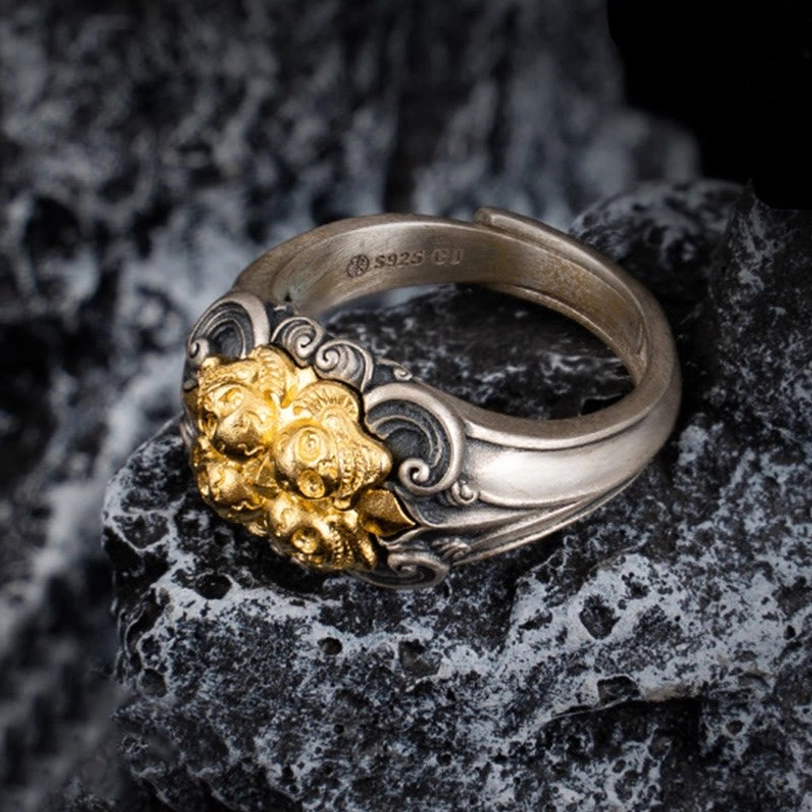 Close-up side view of sterling silver Tibetan skull ring showing S925 stamp and carved scroll patterns on textured stone surface