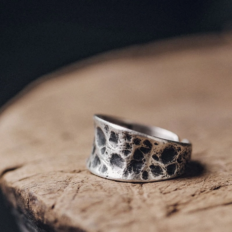 Wide silver bump texture ring side view wooden background handmade Tibetan design