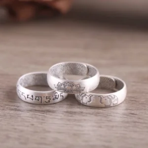 adjustable sterling silver tibetan rings with engraved sacred symbols - flat lay view showing three styles