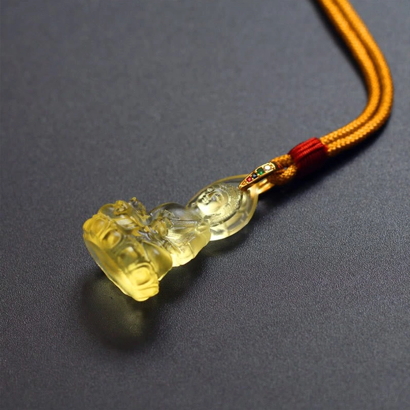 Tathagata Buddha Liuli crystal necklace showing rope cord craftsmanship, woven blue textile with traditional red knot accent and pendant