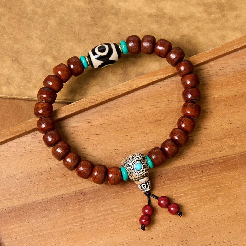 Round brown bone beads with three-eye Dzi stone and turquoise-silver fittings overhead view