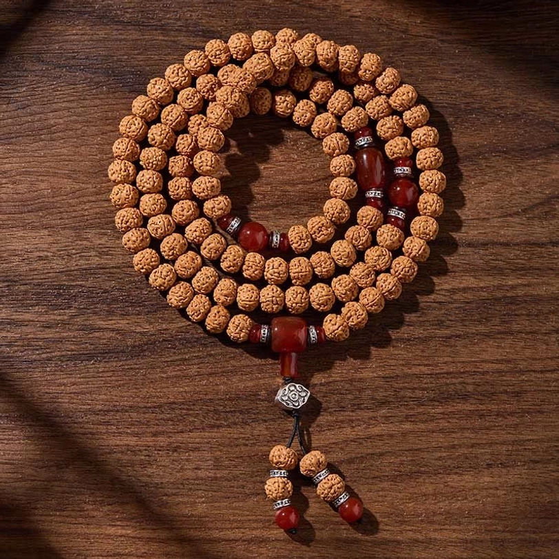 Complete 108-bead bodhi seed mala necklace with matching pendant set, arranged on wooden background with red agate and silver hardware