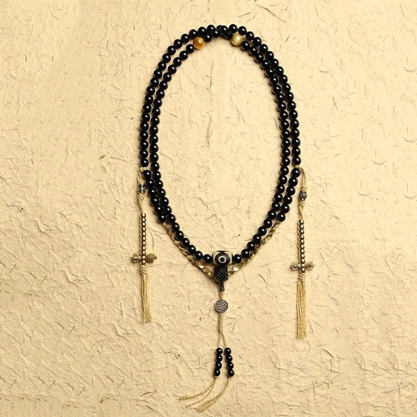 Complete Tibetan 108 mala prayer beads bracelet featuring black onyx beads and central dzi focal bead