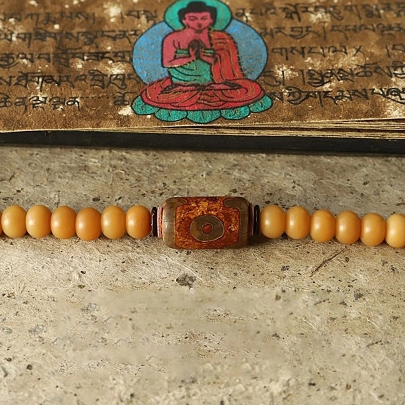 Tibetan 108 mala beads necklace with sacred bodhi seeds, protective Bagua symbol, and traditional Tibetan silver metal work