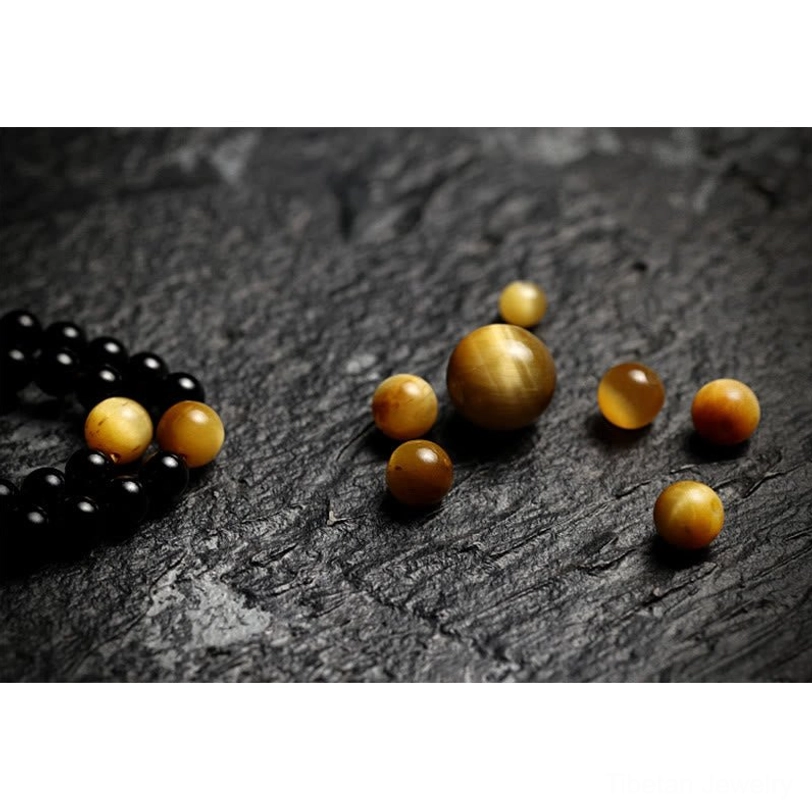 Tibetan 108 mala bracelet gift box packaging showing black onyx and tiger eye beads with protective amulet for spiritual seekers