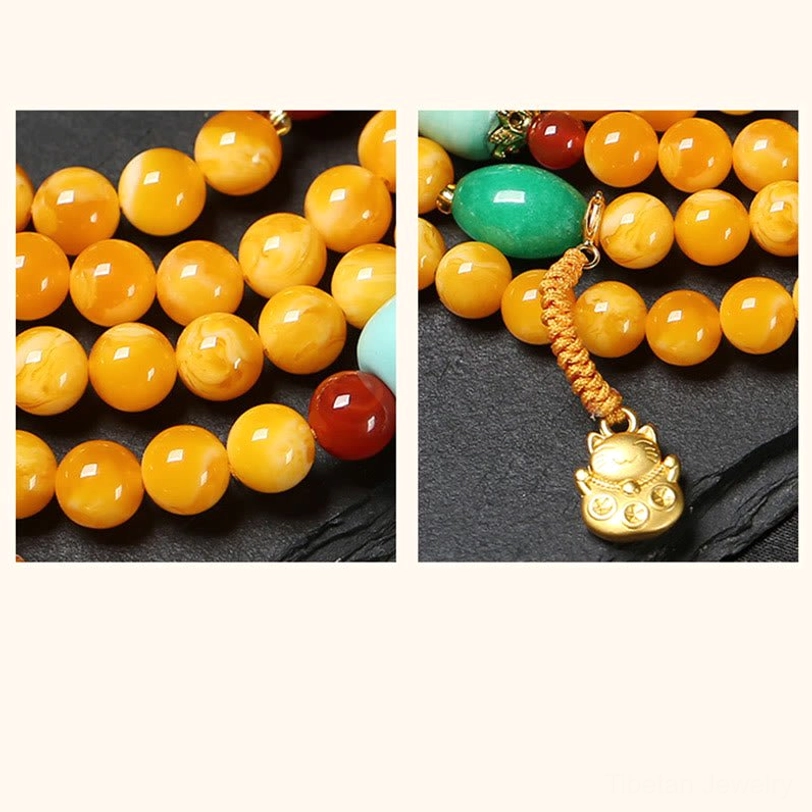 Tibetan 108-bead amber mala necklace with peace buckle guru bead and spiritual charm accents complete set view
