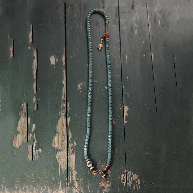 Multi-Layer Tibetan Mala Wrap Bracelets on Wrist with Nine-Eye Dzi Bead and Metal Rings
