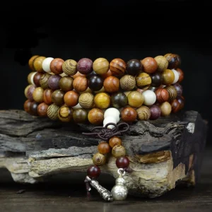 108 natural wood mala beads meditation necklace overhead view with multi-tone wooden prayer beads and silver charms