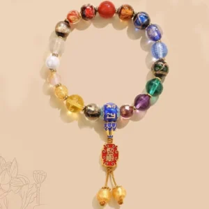 Authentic Tibetan prayer mala with colorful glass beads and dorje vajra pendant, overhead view on lotus-patterned beige background