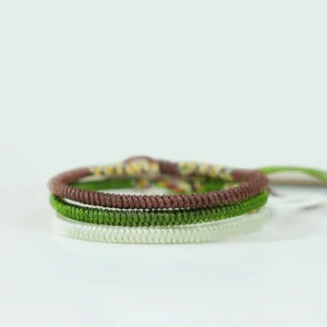 Three-piece Tibetan handwoven bracelet set stacked together showing brown, white, and dark green braided cords
