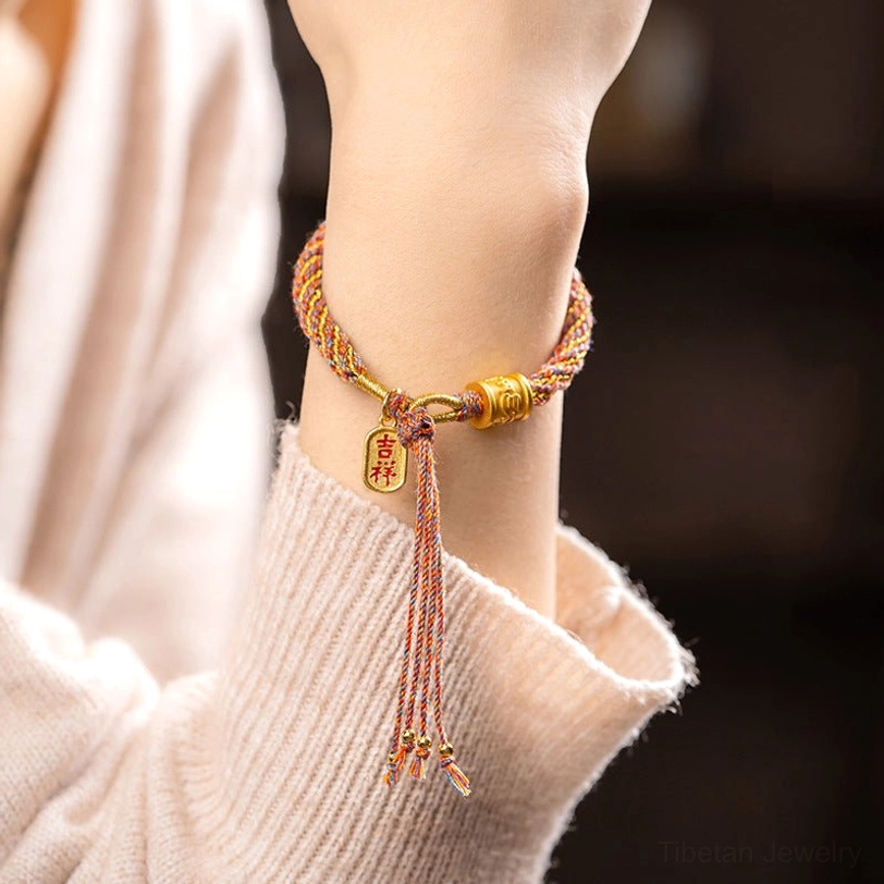 Adjustable Tibetan Om Mani Padme Hum bracelet with woven rope and gold auspicious charm