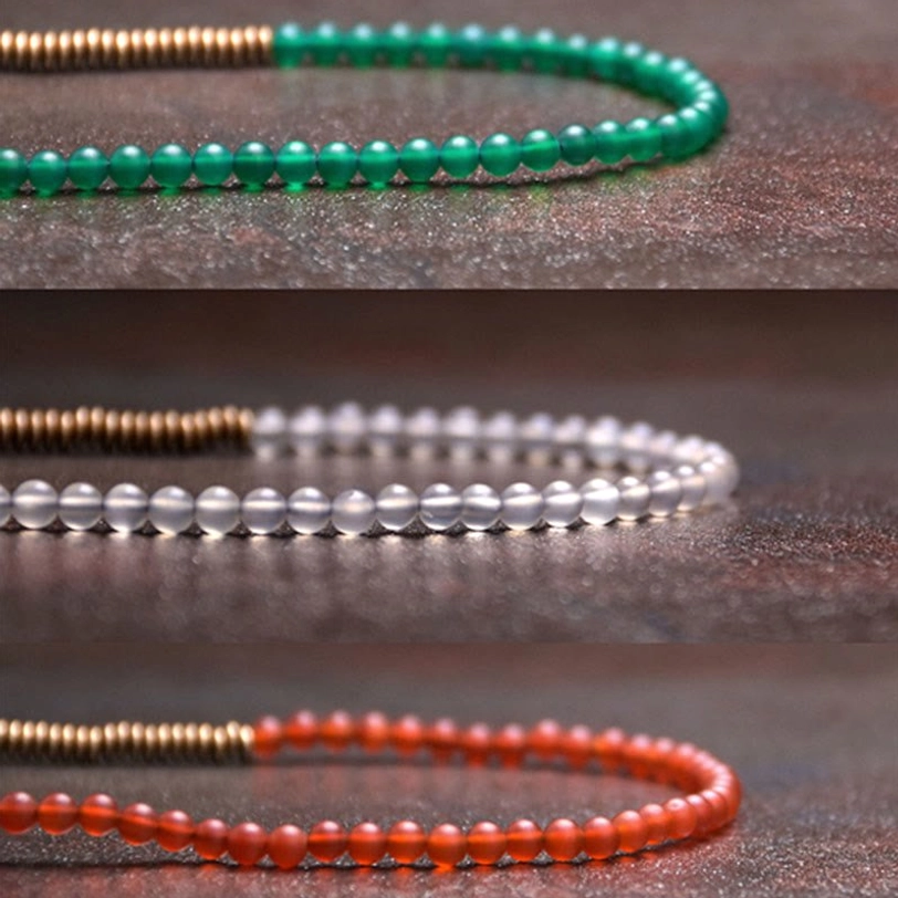 Three styles of Tibetan single-strand agate bracelets displayed flat lay including green agate, white matte bead, and red agate with brass spacers