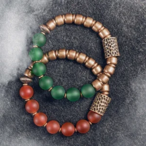 Set of two Tibetan agate copper bracelets featuring red and green agate beads with aged bronze spacer beads