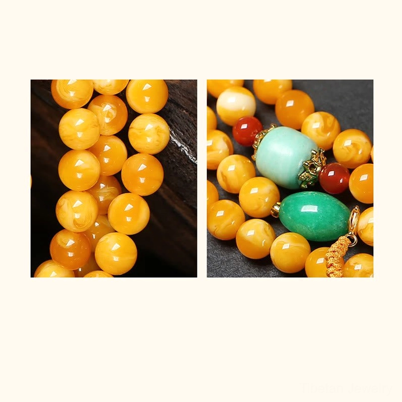 Macro close-up of amber mala beads texture and turquoise red agate inlay details showing handcrafted quality