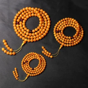 Three Tibetan amber mala necklaces in different bead sizes (6mm, 8mm, 10mm) displayed from above with yellow tassels