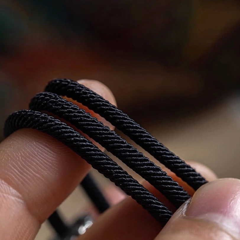 Tibetan double wrap bracelet multiple cord layers stacked showing premium black braided rope thickness