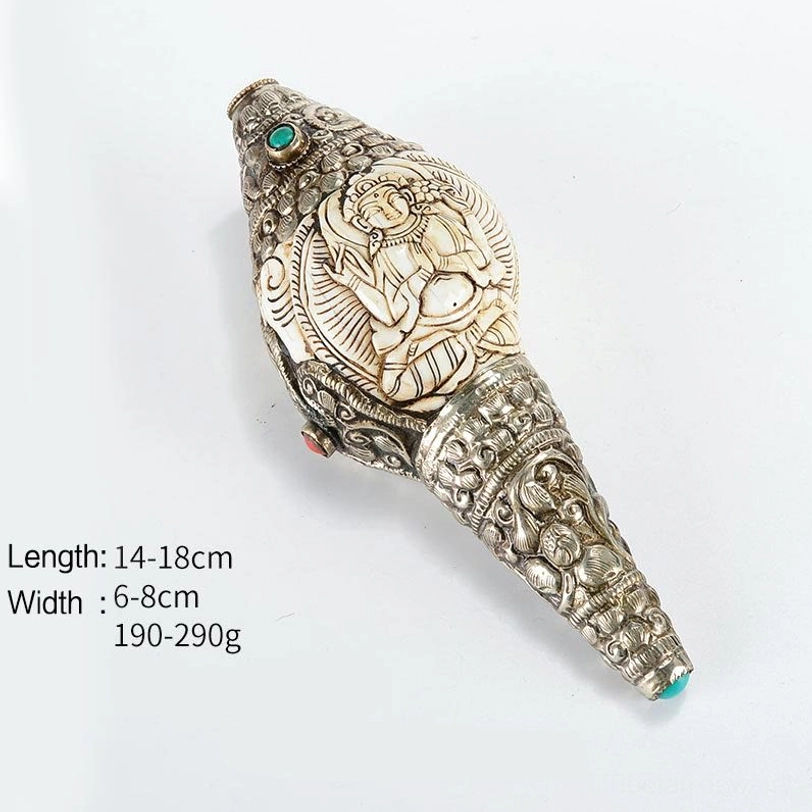 Tibetan Four-Armed Avalokitesvara hand-engraved conch shell with deity carving and intricate silver filigree