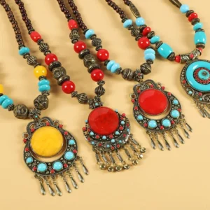 Collection of Tibetan vintage beaded hair clips with varied colored pendants and matching beaded chains on light background