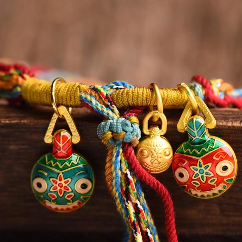 Close-up of Tibetan gold beast enamel pendant with detailed monster face and gold clasp