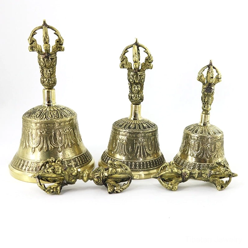 Multiple Tibetan bell and dorje sets in different sizes displaying vintage brass embossed design consistency