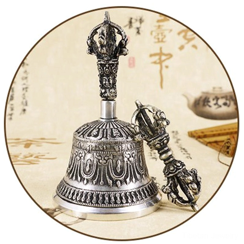 Close-up macro photography of Tibetan bell relief engravings showing Buddhist mantras and spiritual symbols carved in handcrafted copper