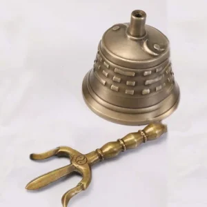 Tibetan bell and vajra dorje separated flat lay showing yin yang symbol on trident prongs and bronze metal texture detail