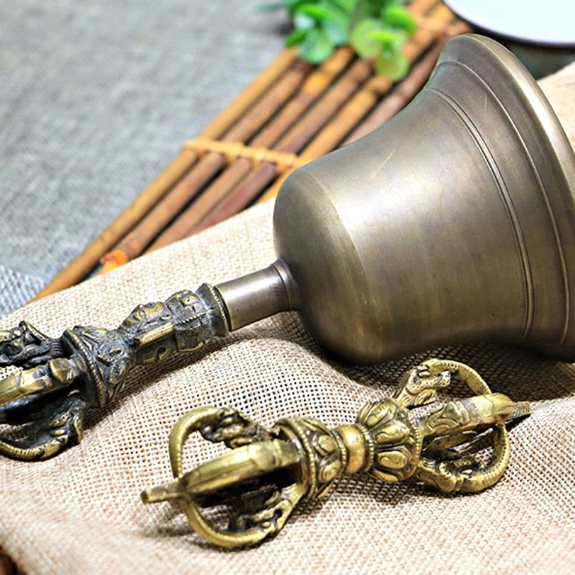 Tibetan bell and vajra dorje handcrafted copper set displaying traditional Himalayan artisan craftsmanship with ornate religious carvings