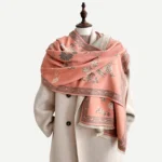 Light pink Tibetan floral bird scarf with bamboo leaf pattern worn by model, studio display
