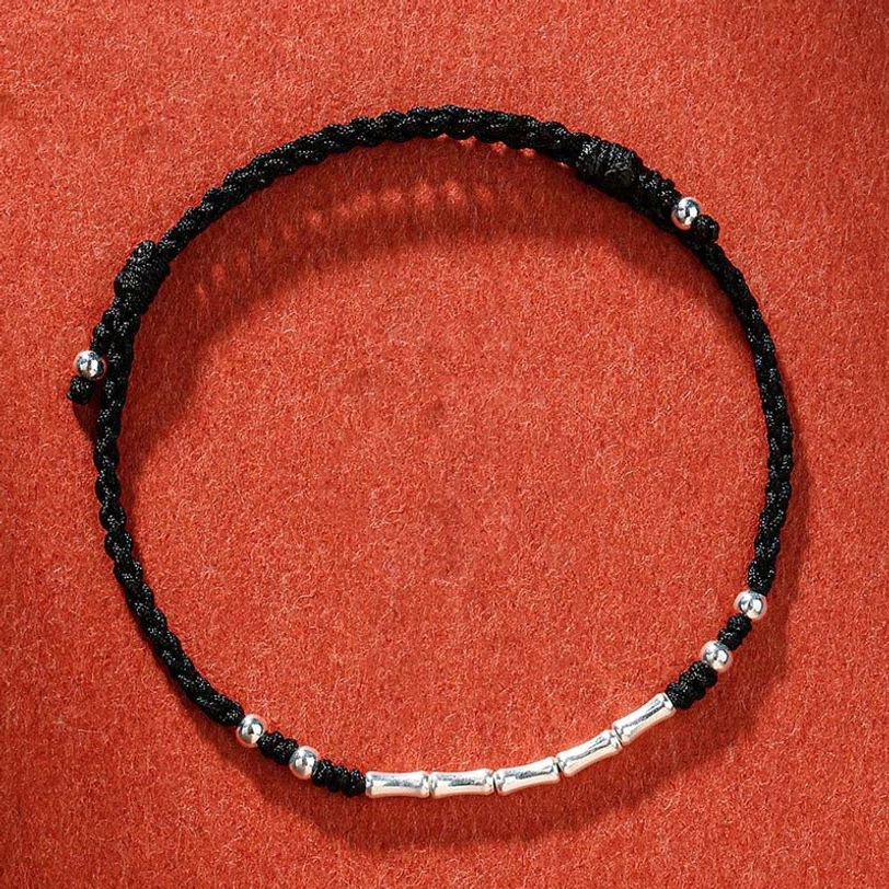 Black Tibetan handmade braided protection bracelet with sleek design and silver bead details for spiritual protection