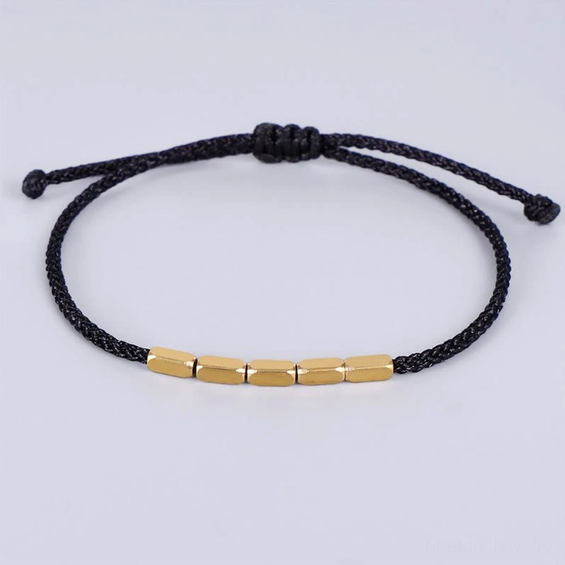 Black Tibetan copper bead protection bracelet with handwoven cord and polished copper beads, sliding knot adjustable fit