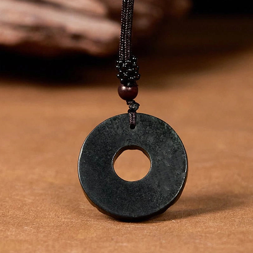 Matte smooth black-green jade peace buckle pendant with braided cord and wooden bead accent