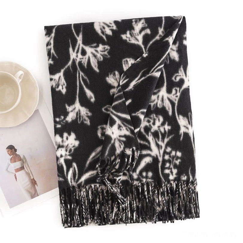 Tibetan shawl black base with white floral prints, flat lay showing monochrome vintage design and fringe border