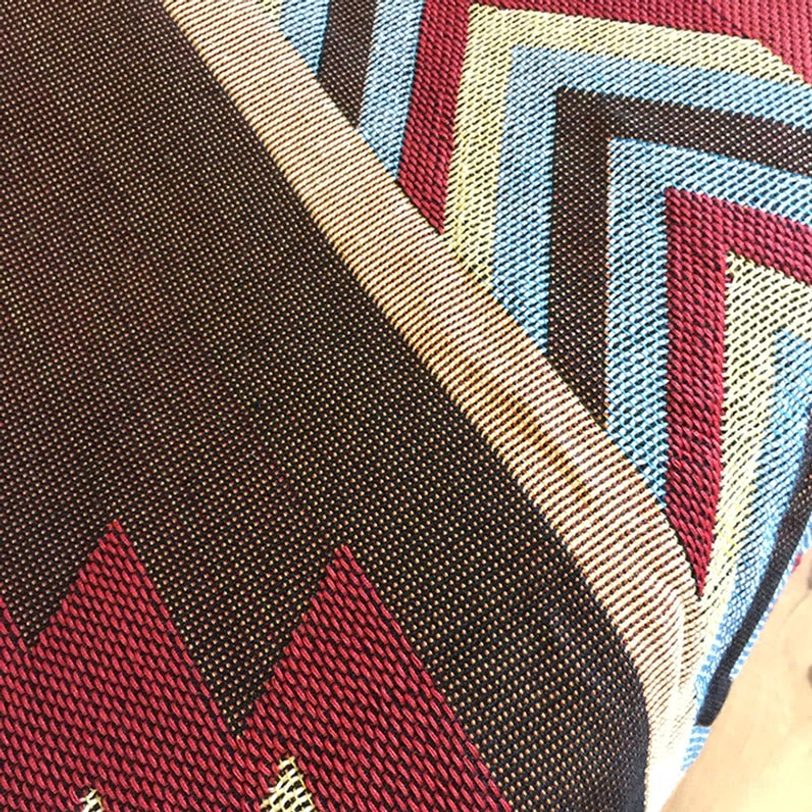 Hand-woven Tibetan blanket chevron stripe pattern detail in warm and cool tones