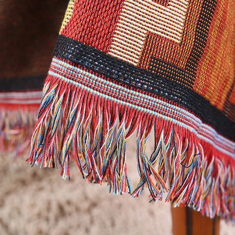 Close-up detail of Tibetan blanket multi-color woven fringe and striped woven band edge