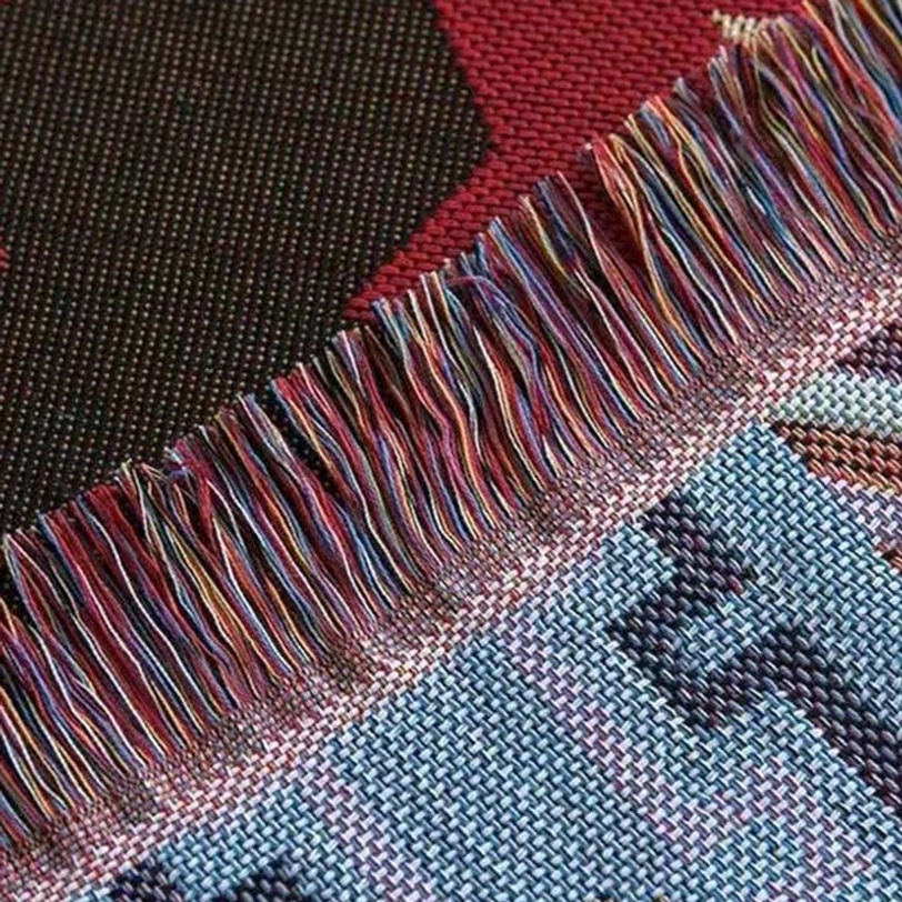 Tibetan blanket fringe edge detail showing multi-color mixed tassels and plain woven base fabric traditional trim