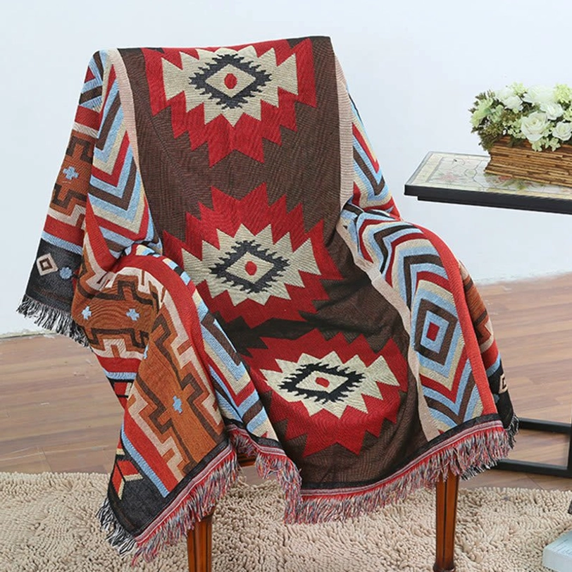 Tibetan geometric throw blanket with tribal patterns and fringe trims displayed in living room setting