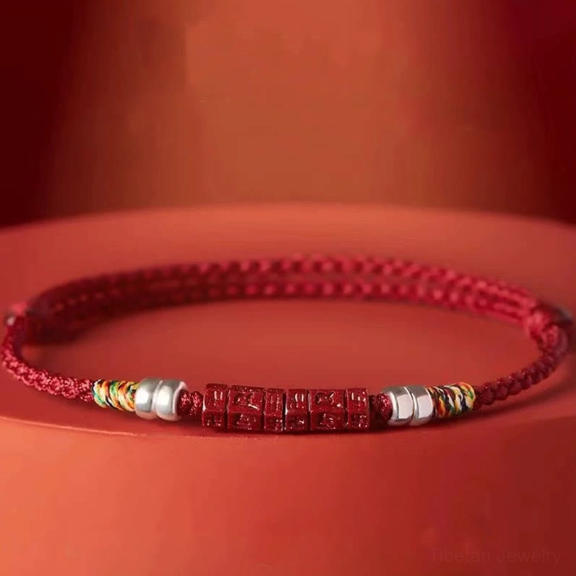Tibetan red cord bracelet close-up side view showing colorful woven knots and polished silver beads