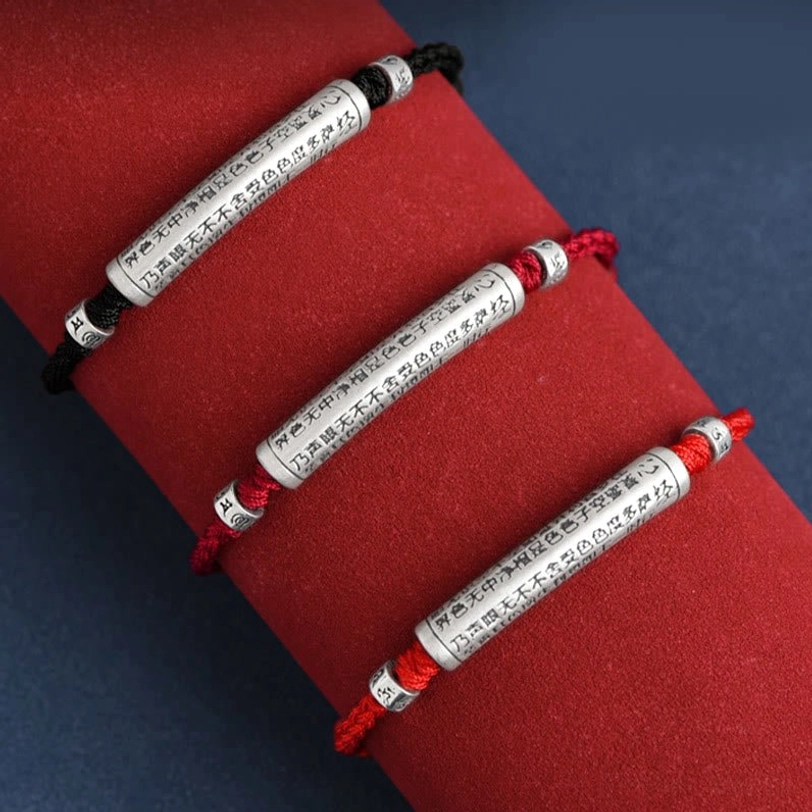 Tibetan blessing bracelet collection showing different rope colors and styles with engraved silver mantras