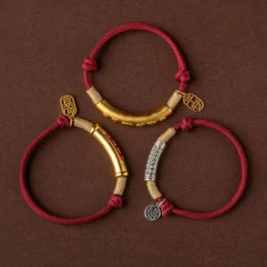 Three styles of Tibetan blessing bracelets with silver and gold metal tubes showing different color variations