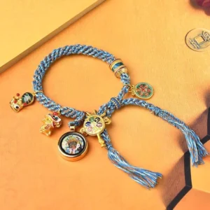 Tibetan blessing bracelet with enamel ornaments and lion dance charm on warm cardboard background